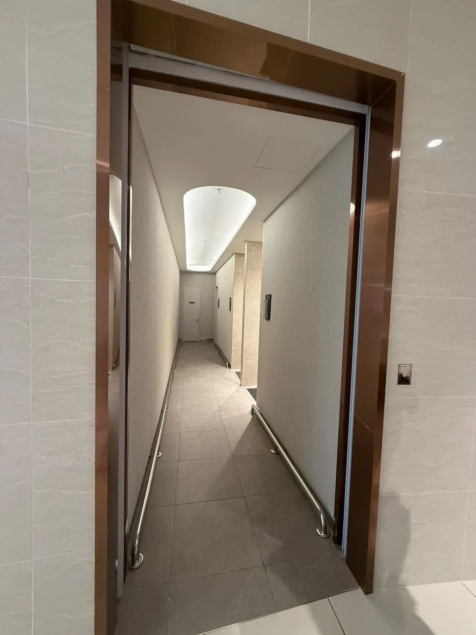 Completed toilet entrance corridor with new door frames and finishes in the upgraded mall toilet.